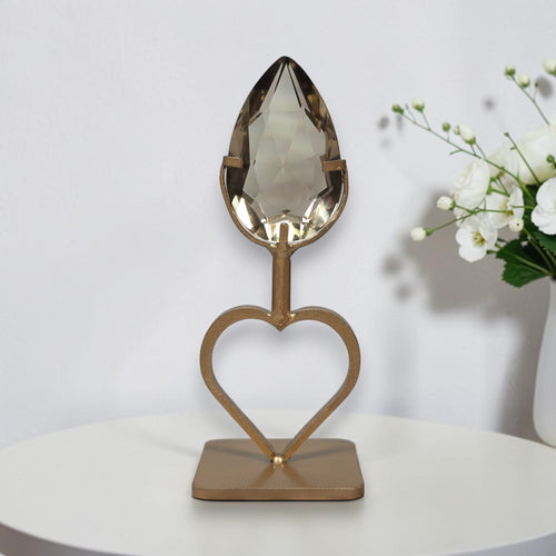 Faceted smoky quartz teardrop on matte gold tone open heart stand, front view