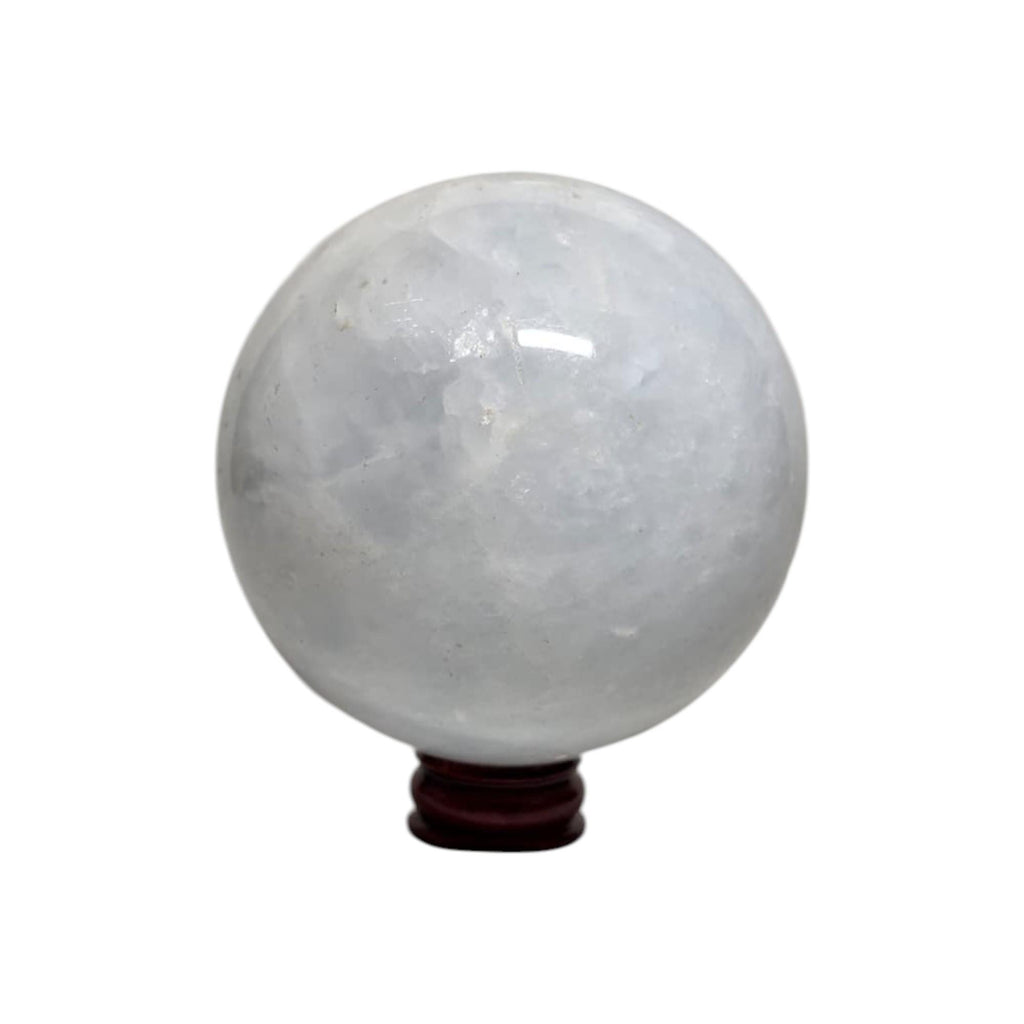 Translucent white-gray calcite sphere on dark wooden base with small stem