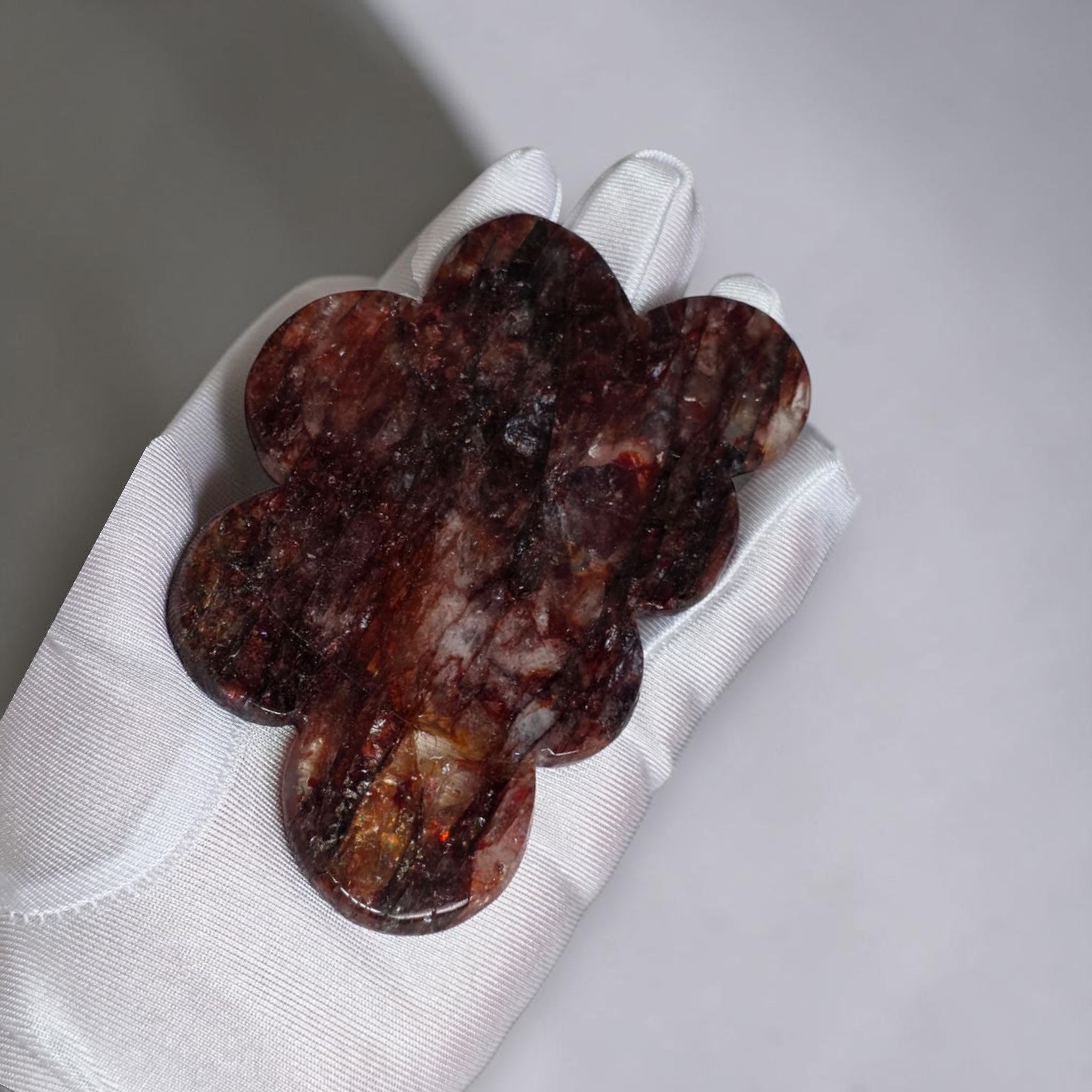 Fire quartz cloud carving closeup showing deep burgundy and red hematoid inclusions