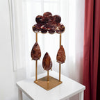 Fire quartz storm cloud and raindrops sculpture on gold metal stand front view