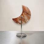 Crescent moon quartz crystal on tall metal stand, orange-brown marbled crescent