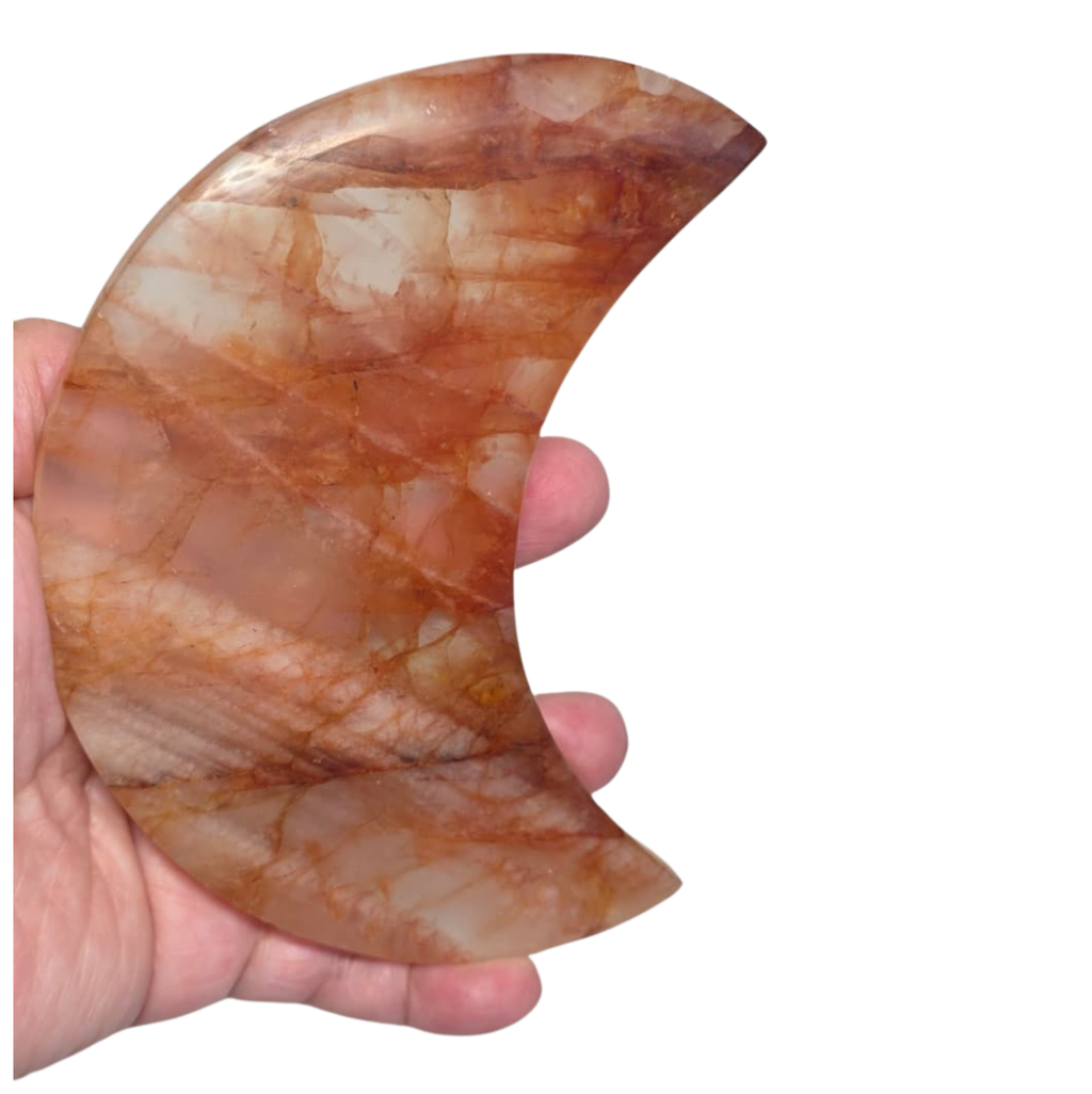 Handheld crescent moon quartz crystal, orange-brown marbled texture with translucent bands