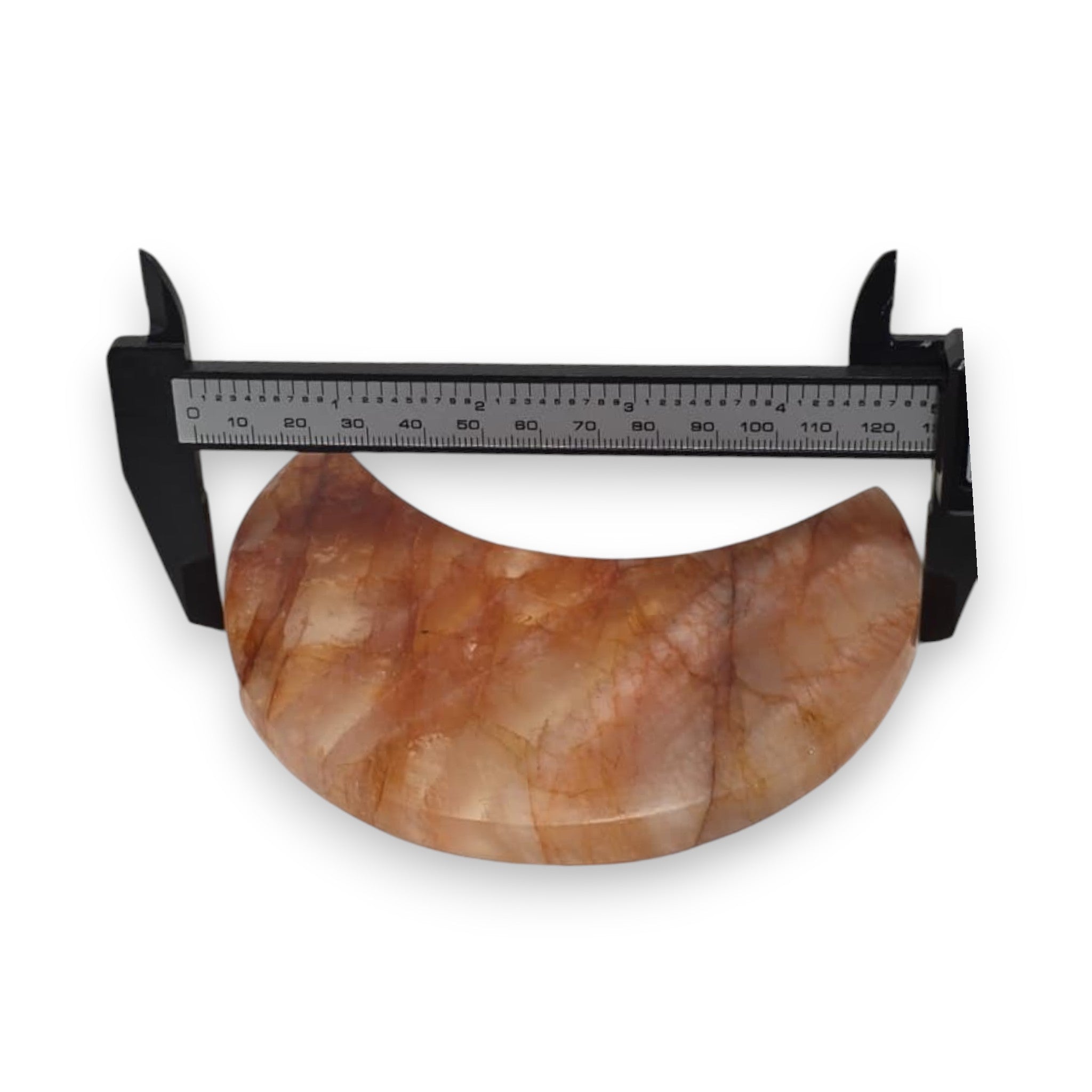 Crescent moon quartz crystal with black caliper measurement, orange and cream marbling