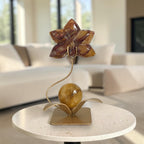 Fire Quartz orchid flower carving on gold stand in living room setting
