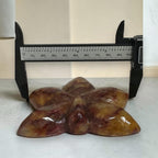 Fire Quartz orchid carving caliper measurement showing ~100mm width
