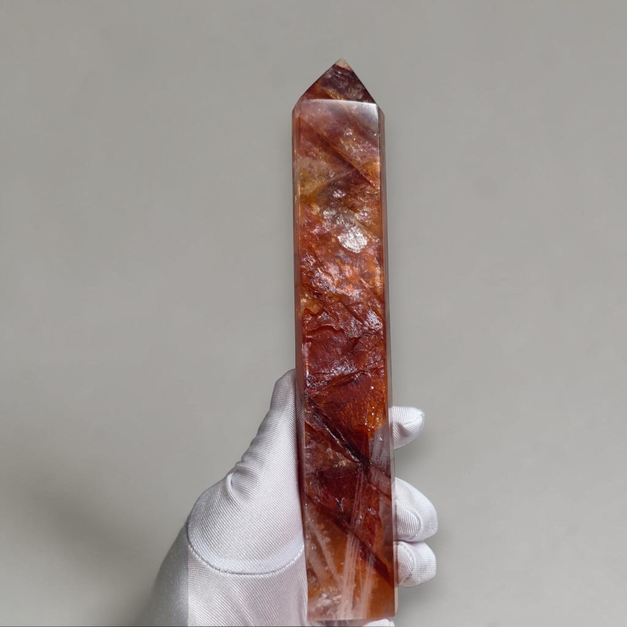 Fire Quartz large tower front view on marble pedestal