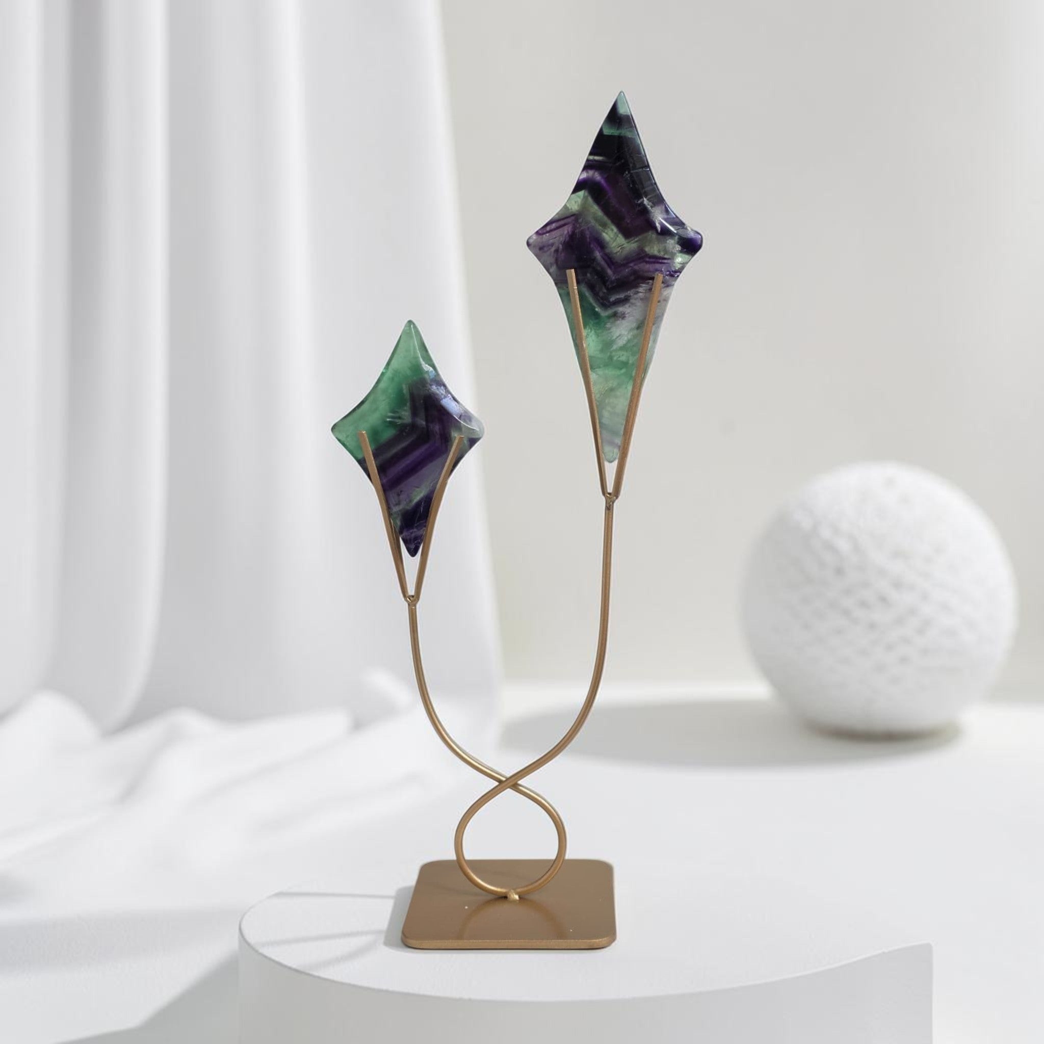 Fluorite star sculptures on gold curved stand with two star pieces