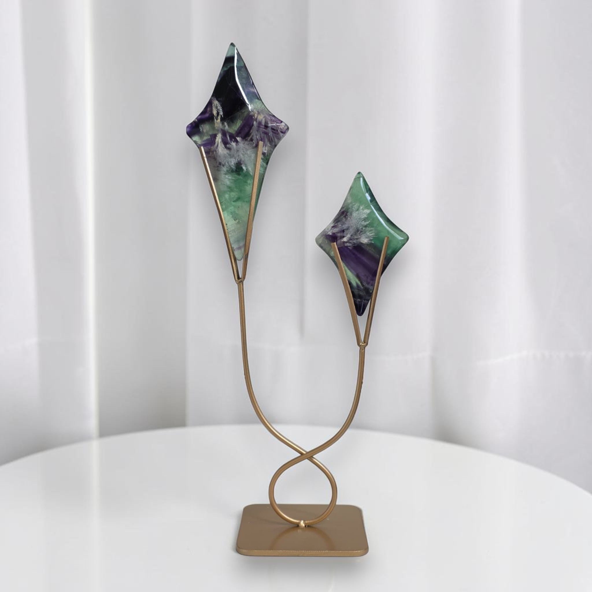 Fluorite star sculptures on gold stand with two angled star shapes