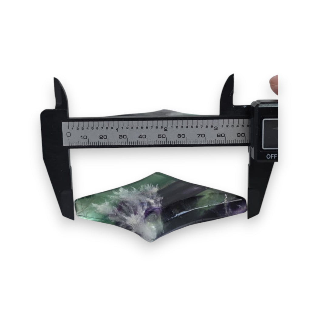 Fluorite star sculpture measured with calipers, green and purple