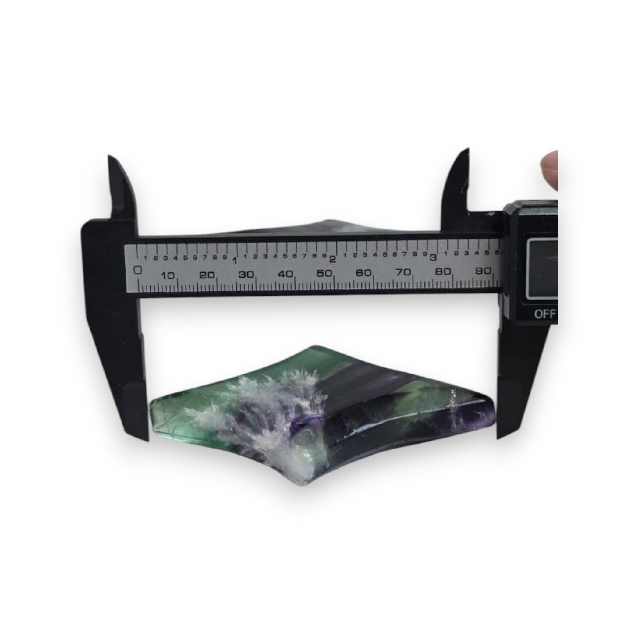 Fluorite star sculpture measured with calipers, green and purple