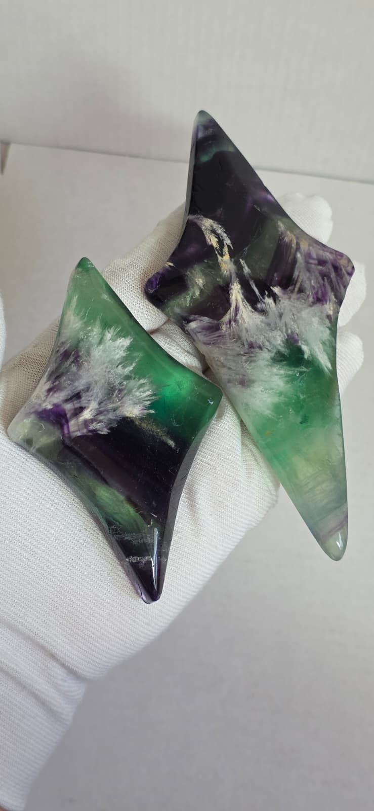 Two fluorite star pieces with green and purple marbling