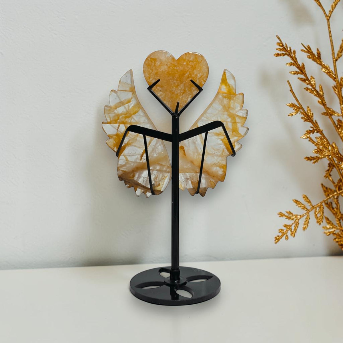 Back view of quartz wings and heart on the black stand