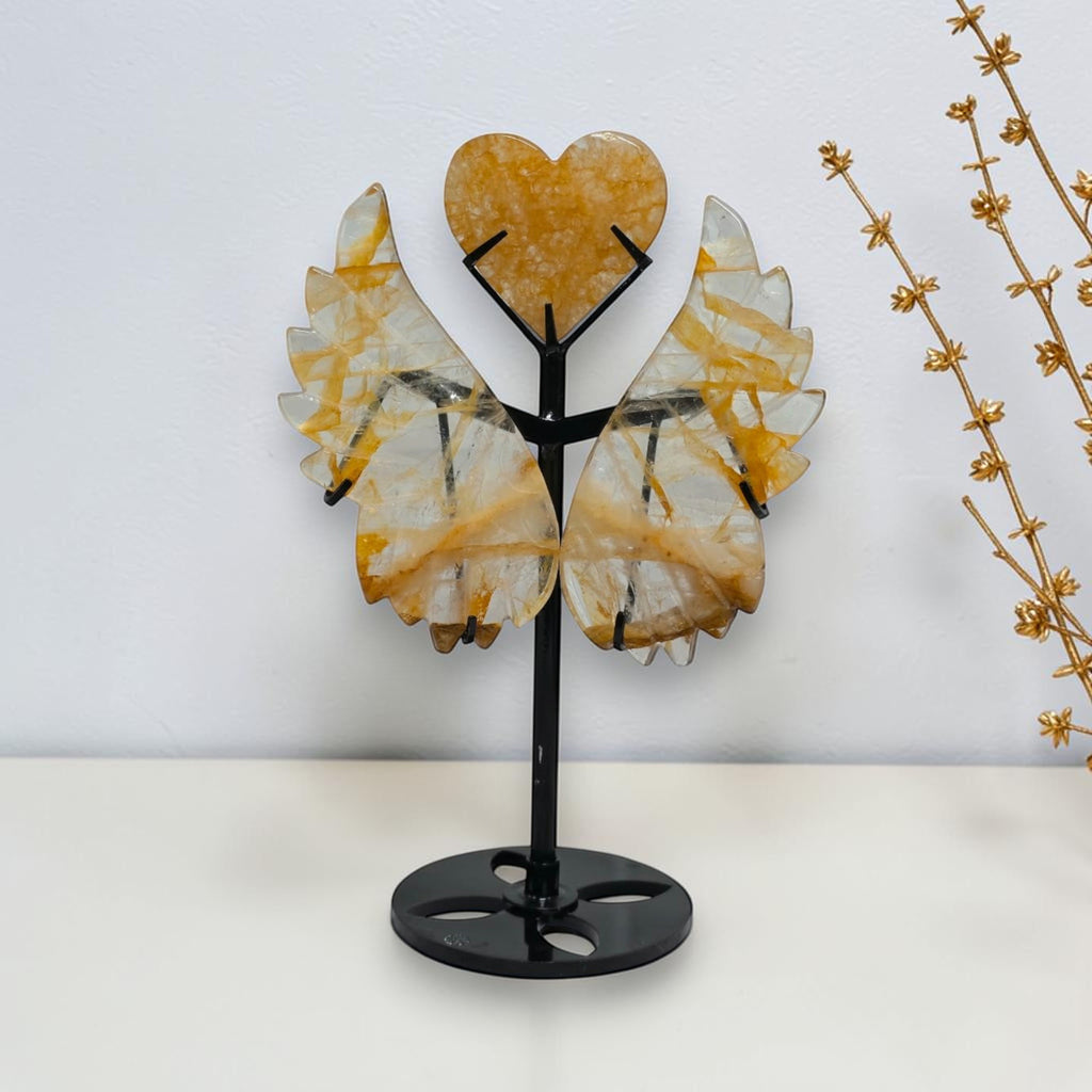 Golden Healer quartz angel wings and heart beside a height ruler