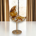 Golden Healer crescent moon displayed on gold colored stand