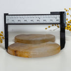 Crescent quartz moon carvings beside a caliper