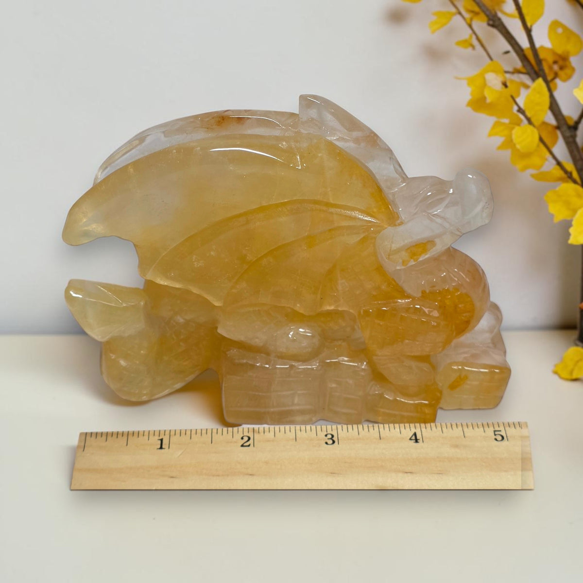 Quartz dragon beside ruler showing approximate length