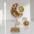 Golden healer moon and flower sculpture with gold botanical decor