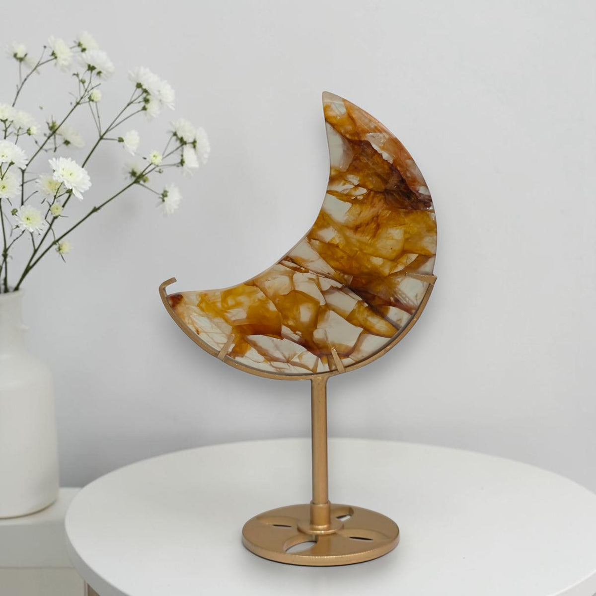 Golden Healer crescent moon crystal on stand from another angle