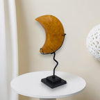 Decorative item with a crescent moon design on a white surface