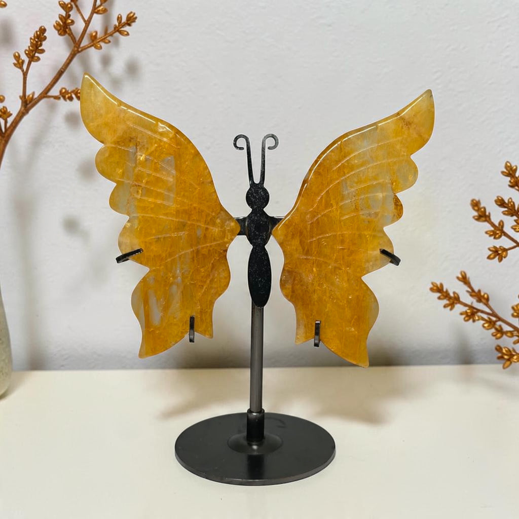 Small Golden Healer quartz butterfly with yellow wings on a black round stand