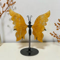 Small Golden Healer quartz butterfly with yellow wings on a black round stand