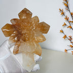 Closeup of sculpted roses and honey gold tones in the quartz cross
