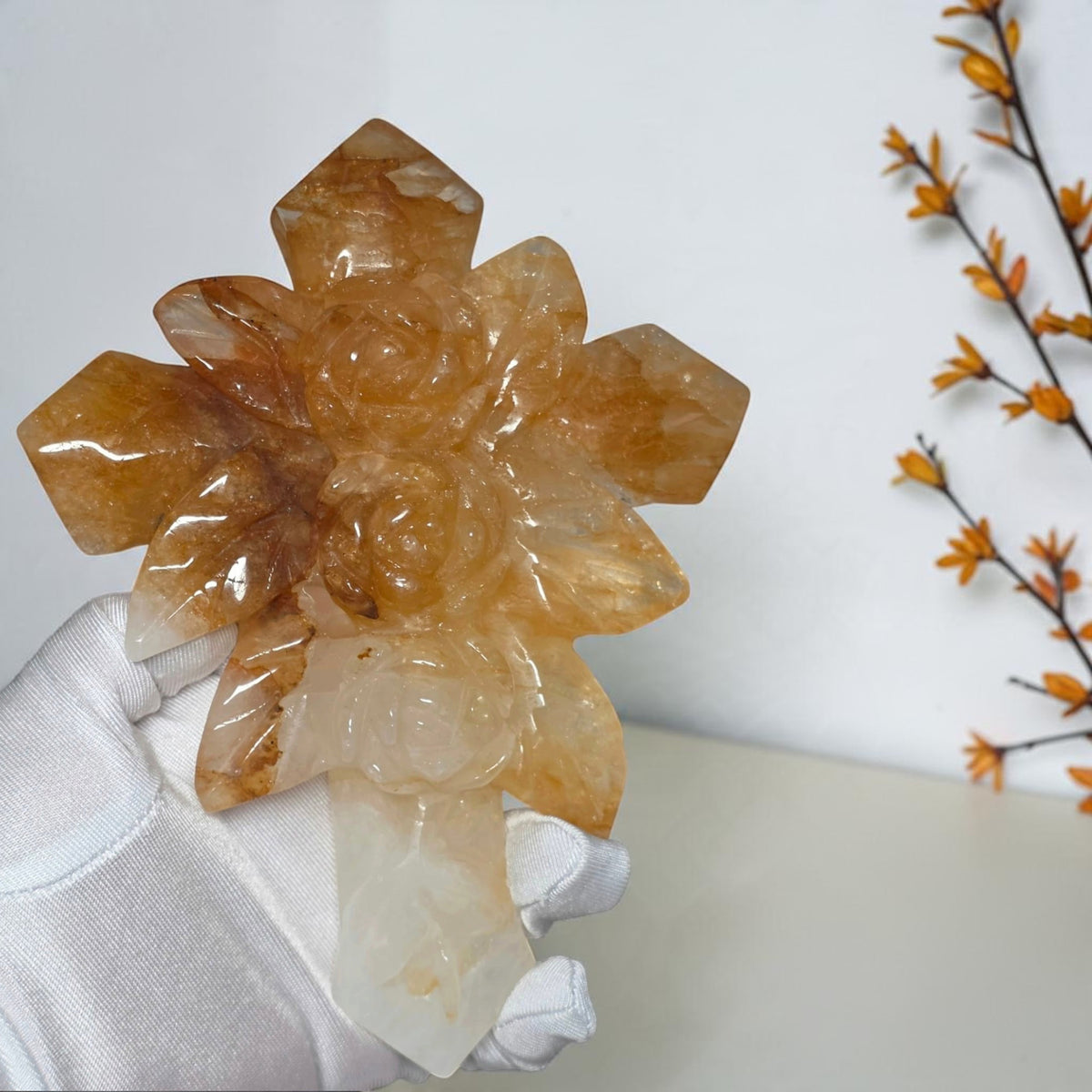 Closeup of sculpted roses and honey gold tones in the quartz cross