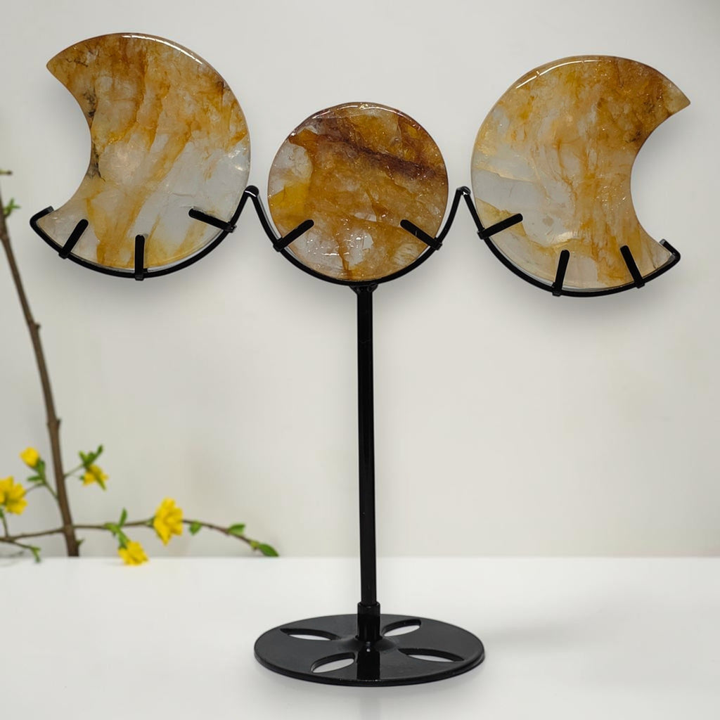 Golden Healer Quartz triple moon display on a black metal stand