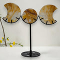 Golden Healer Quartz triple moon display on a black metal stand