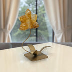 Golden Healer Quartz orchid carving on gold stand home decor setting