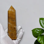 Golden Healer Quartz tower front view on white background