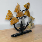 Angled view of the Golden Healer quartz butterfly tree on its black base
