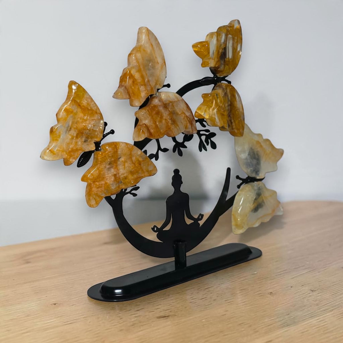 Angled view of the Golden Healer quartz butterfly tree on its black base