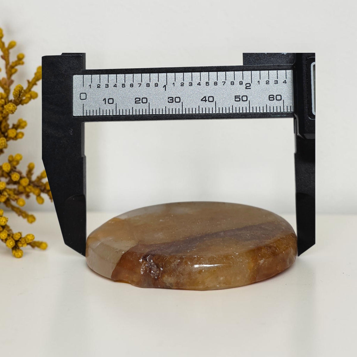 Full moon quartz carving measured with a caliper
