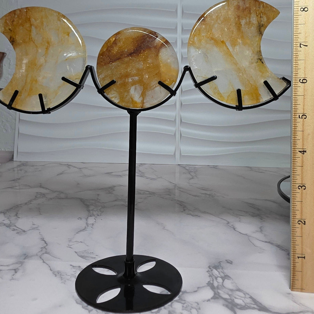 Triple moon display beside an inch ruler showing overall height