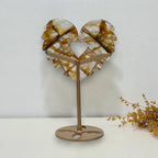 Back view of Golden Healer quartz angel wing heart and stand