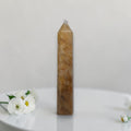 Golden quartz tower with pointed crystal top, amber/gold, vertical display