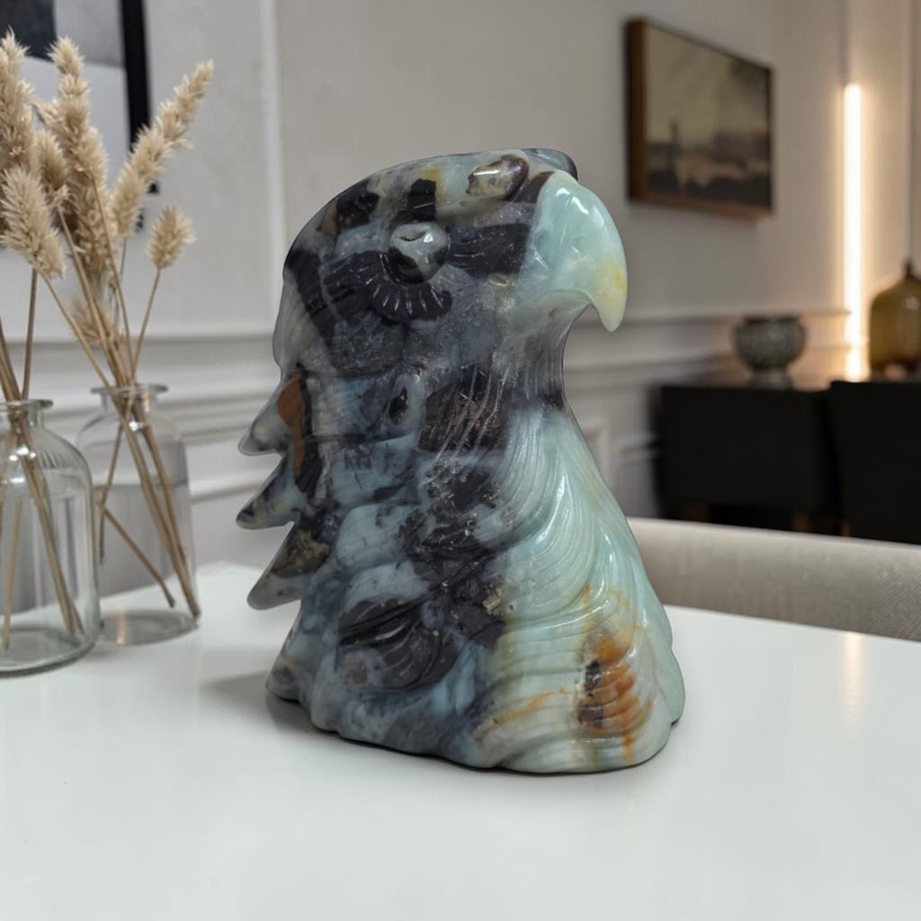 Amazonite eagle head sculpture on side, blue-green and dark gray with feather details