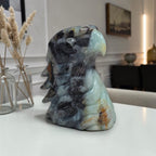 Amazonite eagle head sculpture on side, blue-green and dark gray with feather details