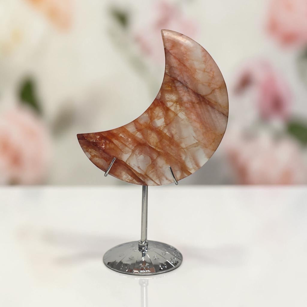 Crescent moon quartz crystal on metal stand, reddish-brown stone with curved shape