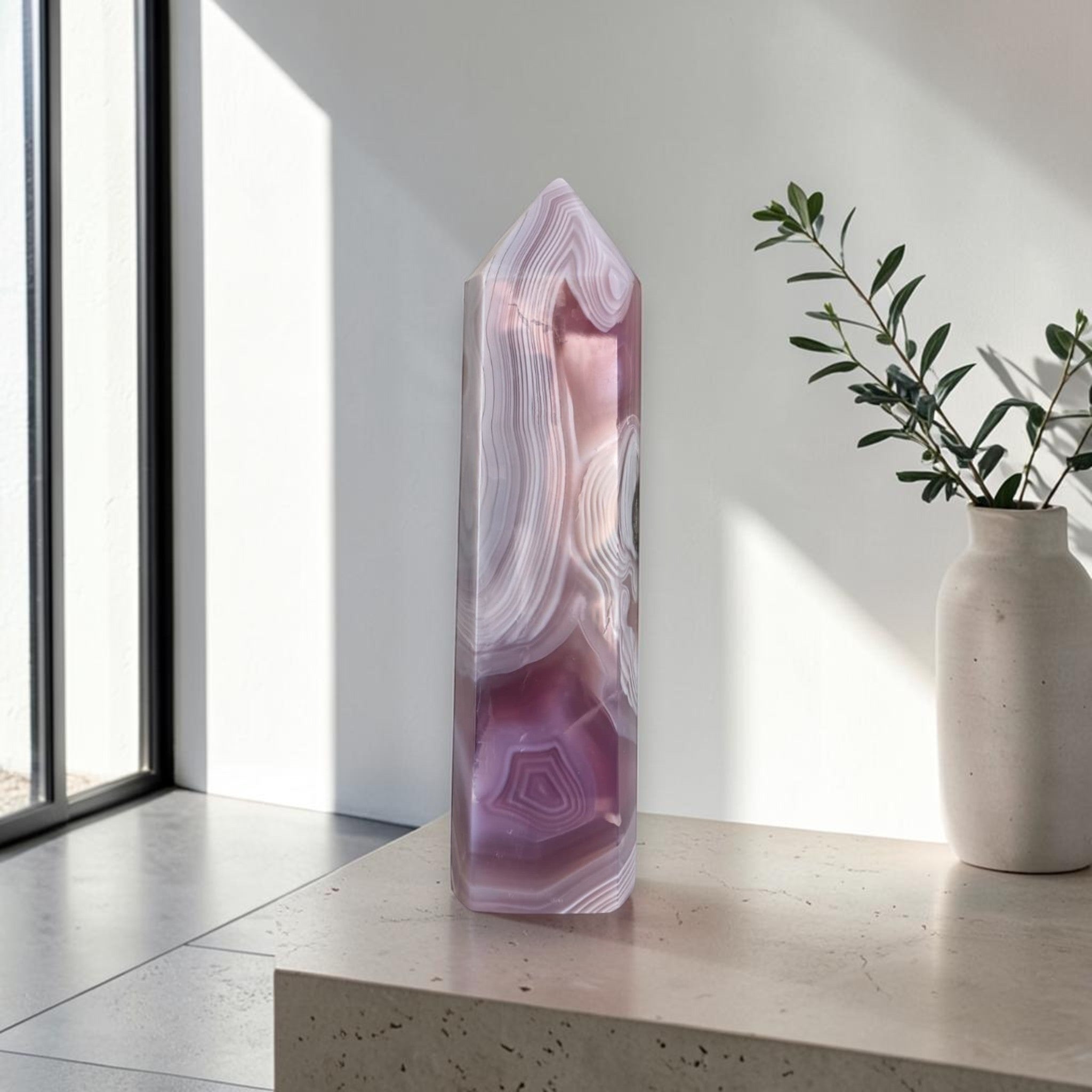 Lavender and rose agate tower crystal with banded layers and stone pocket at center