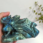 Close view of blue, teal and golden green flashes on the carved labradorite dragon