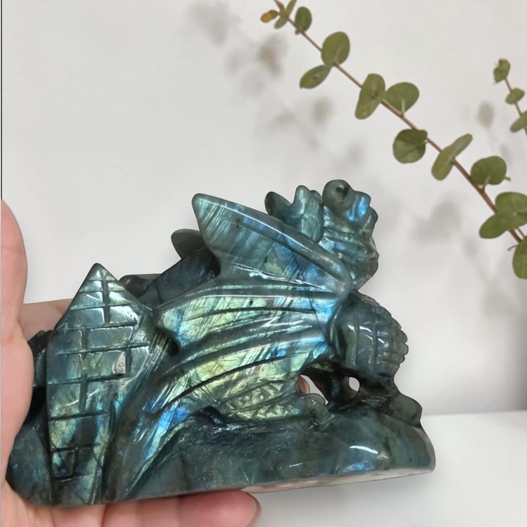 Angled view of labradorite dragon with bright blue flash on its face
