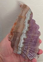 Handheld amethyst lace agate butterfly wing, purple and tan with cream wavy lines