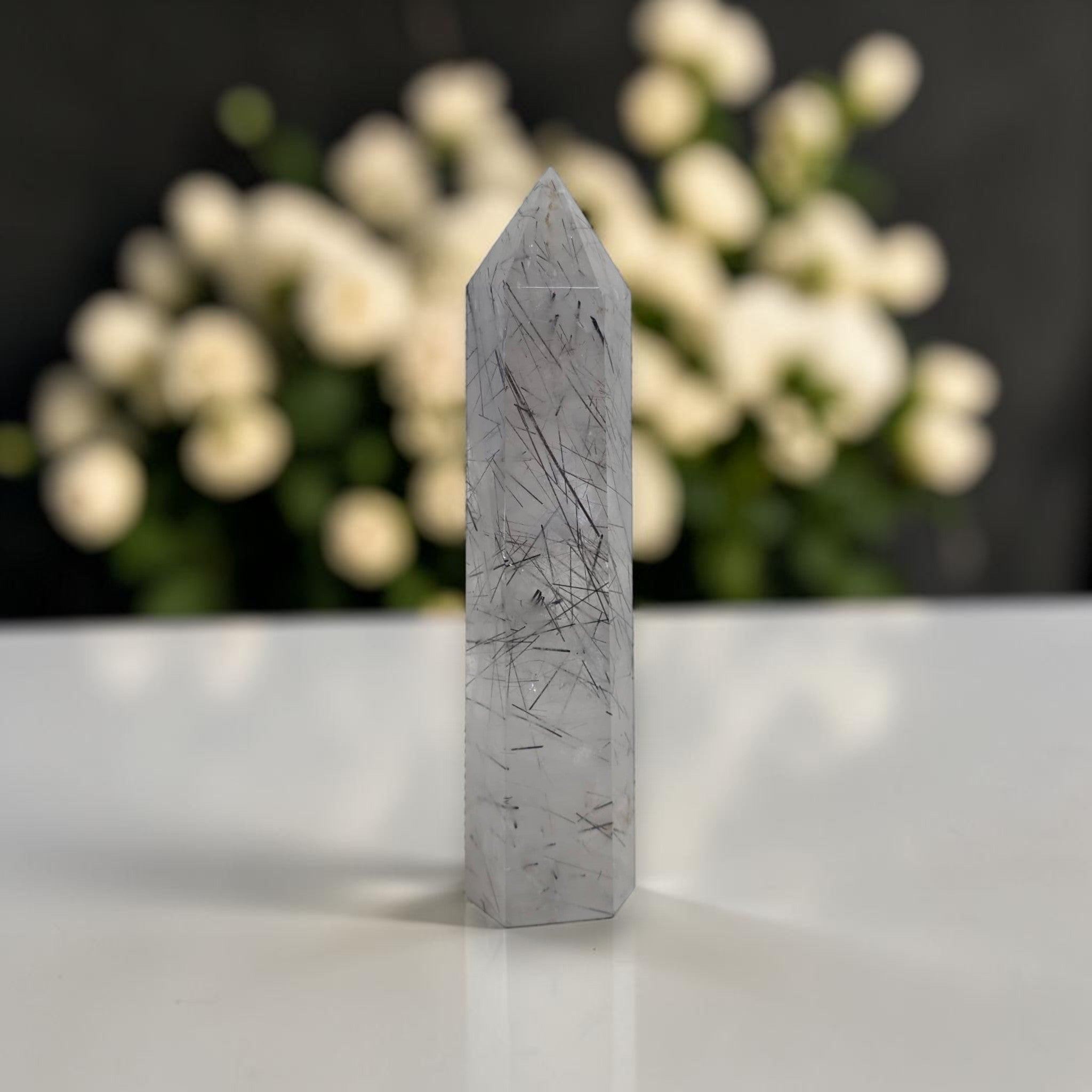 Rutilated quartz obelisk tower in gray with dark needle rutiles and sharp point