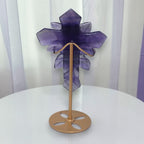 Purple fluorite cross ornament with carved rose details, back view on bronze stand