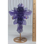 Large purple fluorite cross ornament with carved rose details, shown with measuring tape
