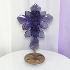 Large purple fluorite cross ornament with carved rose details on bronze stand