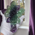 Rainbow fluorite cross sculpture with carved rose face on metal stand, glimmers