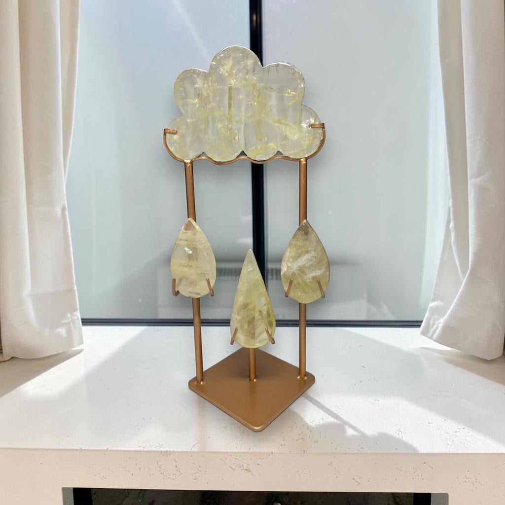 Crystal cloud sculpture with five hanging yellow translucent teardrop crystals on a gold base